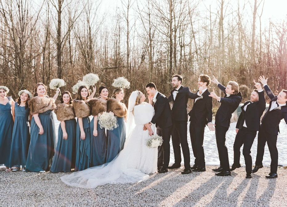 Wedding party celebrating bride and groom in a winter wedding photo at Retreat 21 near Columbus, Ohio
